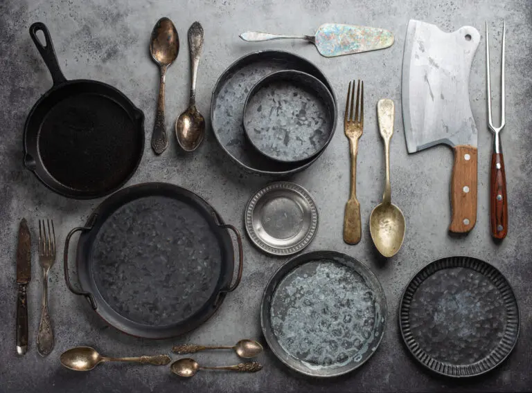 Old vintage tableware and kitchen utensils on rustic stone backg